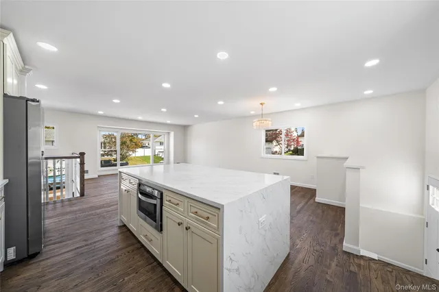 a kitchen with a sink and wooden floor