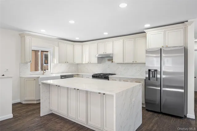 a kitchen with a refrigerator a sink and cabinets