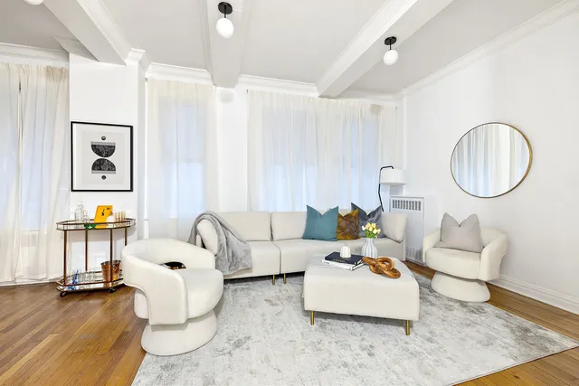 a living room with furniture and a bed