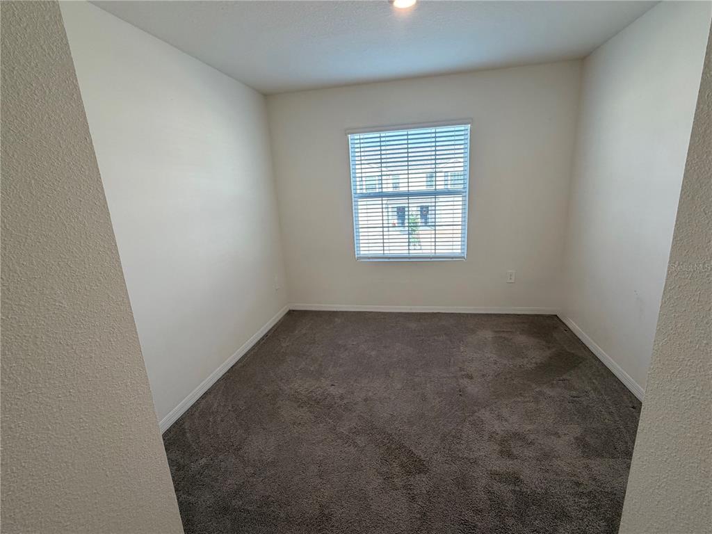 17534 Crescent Moon Loop Bradenton, FL 34211 - Photo 16 of 18 an empty room with a window