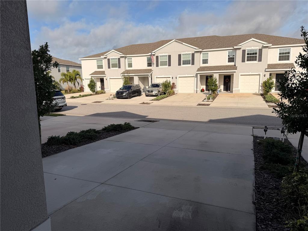17534 Crescent Moon Loop Bradenton, FL 34211 - Photo 2 of 18 a view of multiple houses with a street