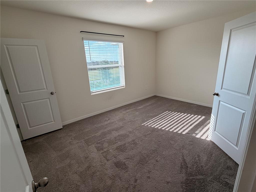 17534 Crescent Moon Loop Bradenton, FL 34211 - Photo 10 of 18 an empty room with windows
