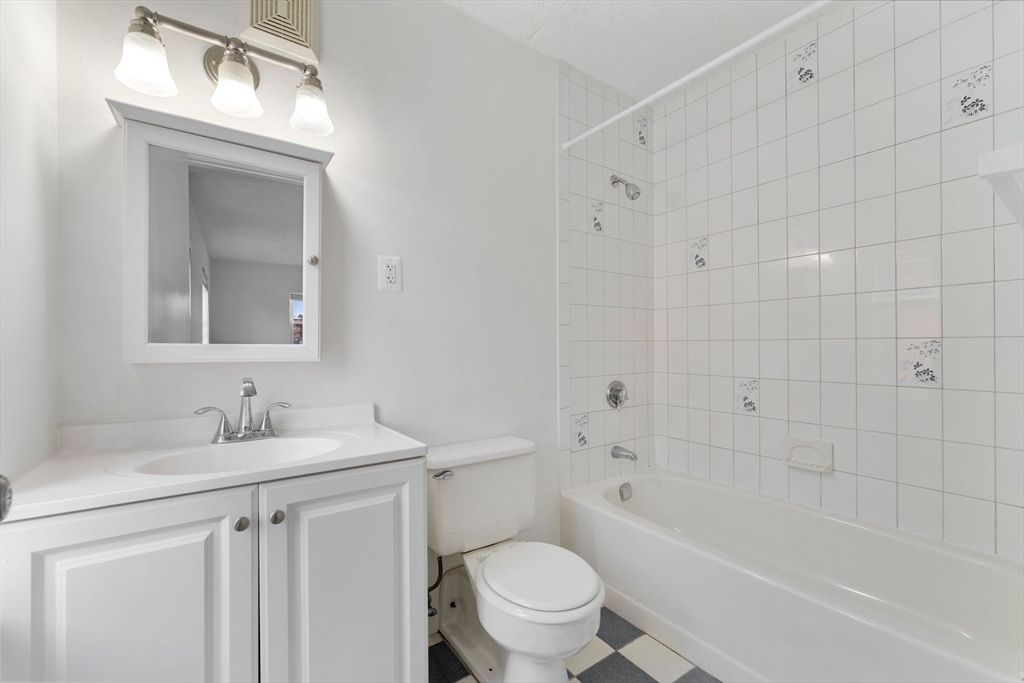 31 Spring Street, Unit 308 Watertown, MA 02472 - Photo 11 of 37 a bathroom with a sink toilet vanity and shower