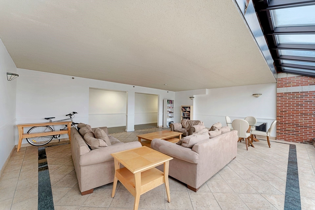 31 Spring Street, Unit 308 Watertown, MA 02472 - Photo 17 of 37 a living room with furniture and wooden floor