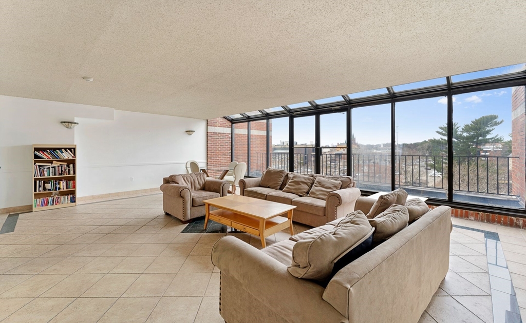 31 Spring Street, Unit 308 Watertown, MA 02472 - Photo 19 of 37 a living room with furniture and large windows