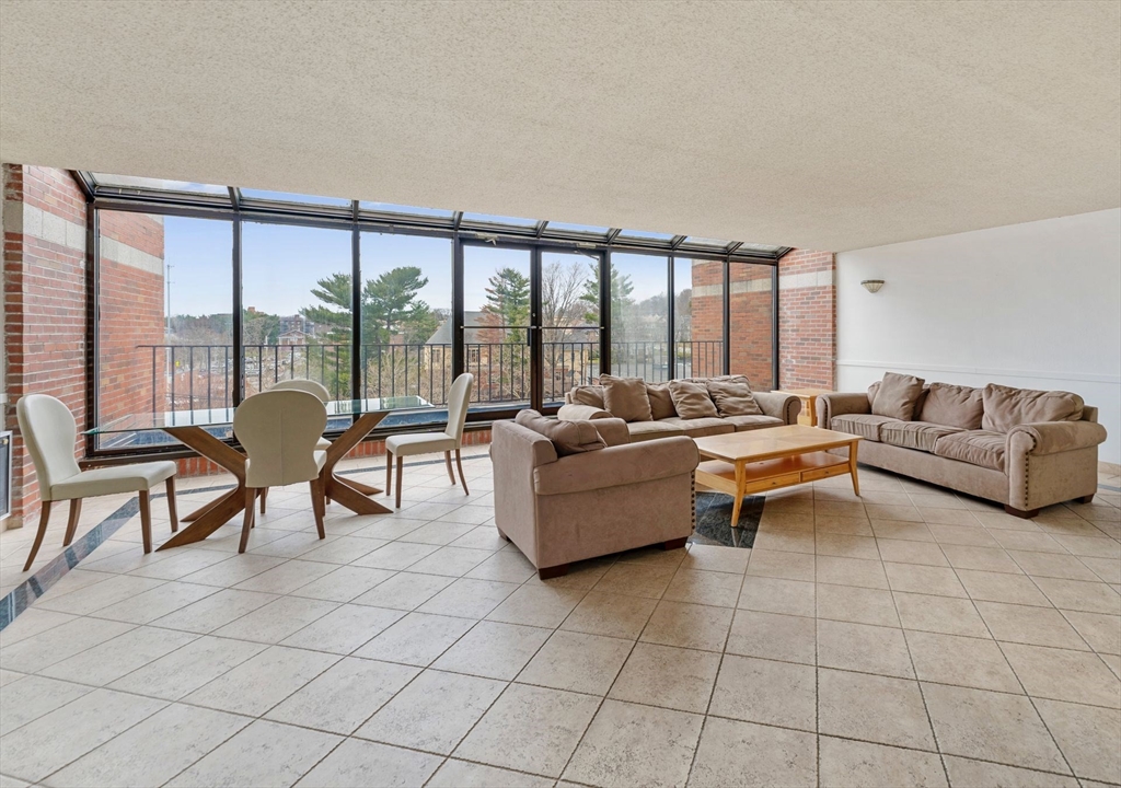 31 Spring Street, Unit 308 Watertown, MA 02472 - Photo 20 of 37 a living room with furniture and a large window