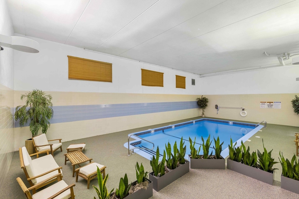 31 Spring Street, Unit 308 Watertown, MA 02472 - Photo 27 of 37 a living room with furniture and flowers
