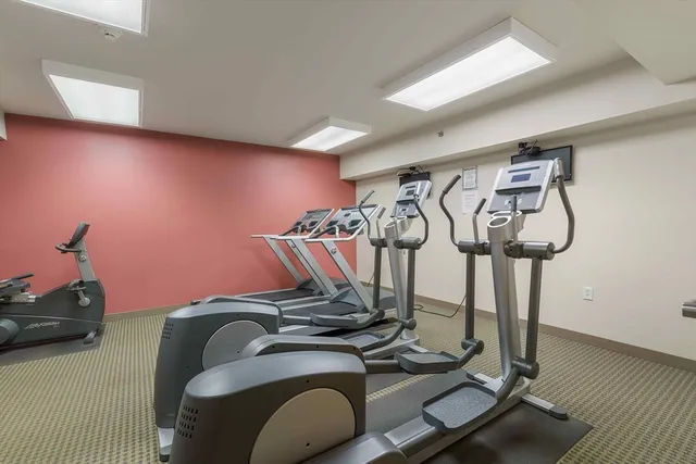 a room with gym equipment and white walls