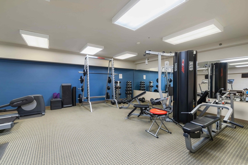 31 Spring Street, Unit 308 Watertown, MA 02472 - Photo 31 of 37 a room with gym equipment and white walls