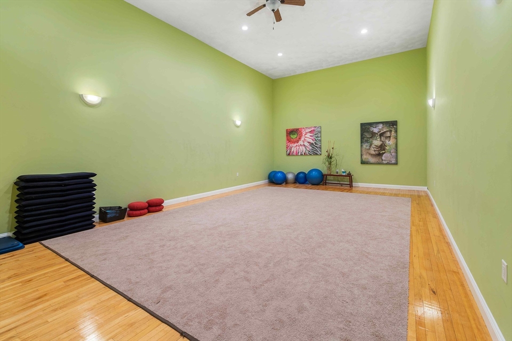 31 Spring Street, Unit 308 Watertown, MA 02472 - Photo 37 of 37 a bedroom with a bed and a chandelier