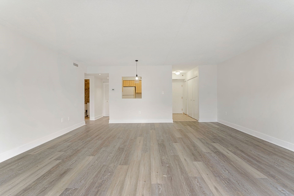 31 Spring Street, Unit 308 Watertown, MA 02472 - Photo 6 of 37 a view of an empty room and wooden floor