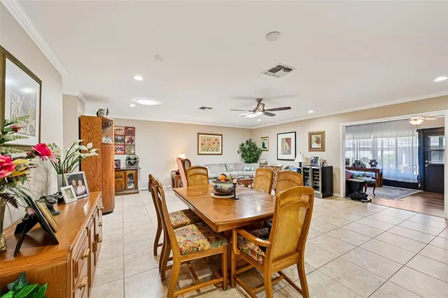 a kitchen with stainless steel appliances kitchen island granite countertop a dining table and chairs