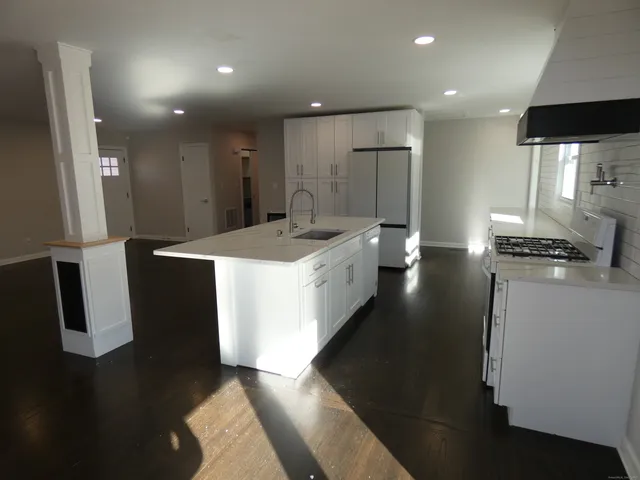 a bathroom with a sink a toilet and a shower