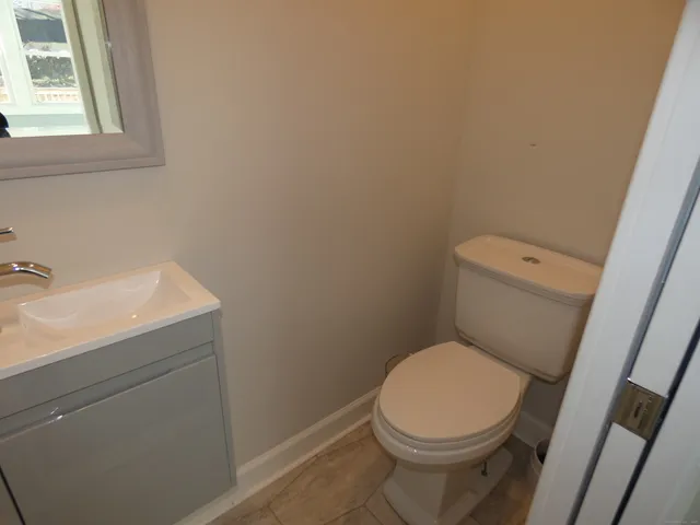 a white toilet sitting next to a bathroom sink
