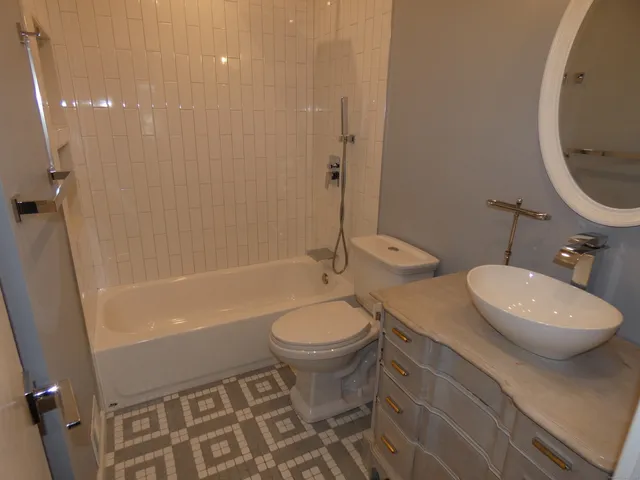a bathroom with a toilet a sink and bathtub