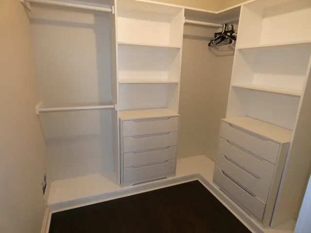 a view of walk in closet with empty racks