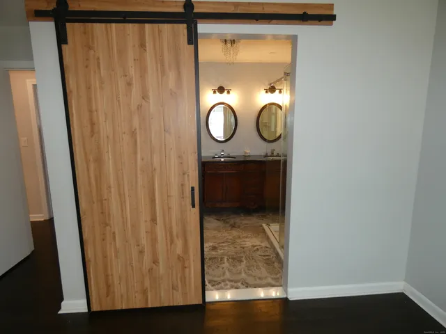 a bathroom with a shower curtain and mirror