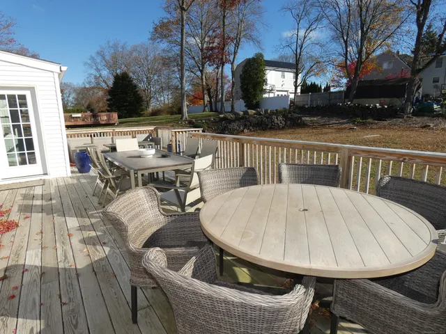 a view of outdoor sitting area with furniture and wooden floor