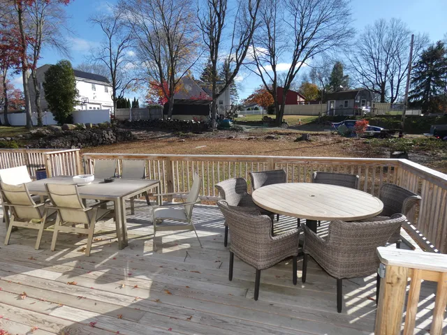 a view of a patio with table and chairs and potted plants