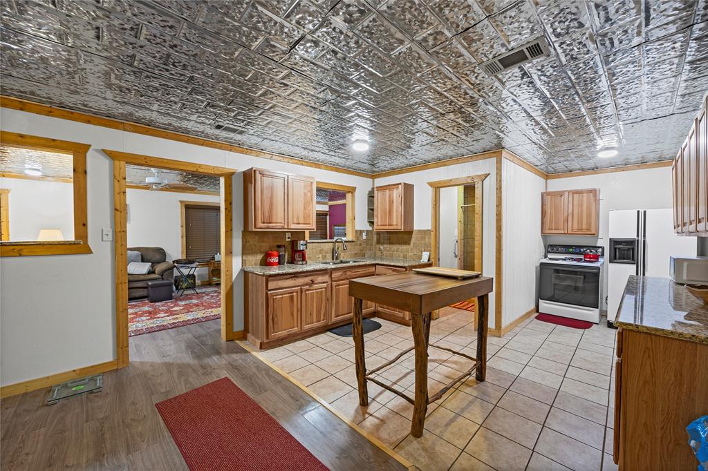 153 Center Loop Whitney, TX 76692 - Photo 2 of 10 a room with stainless steel appliances lots of wooden furniture and large windows