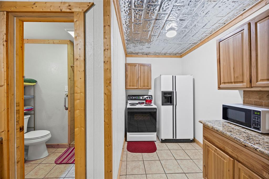 153 Center Loop Whitney, TX 76692 - Photo 4 of 10 a bathroom with a granite countertop sink and a mirror