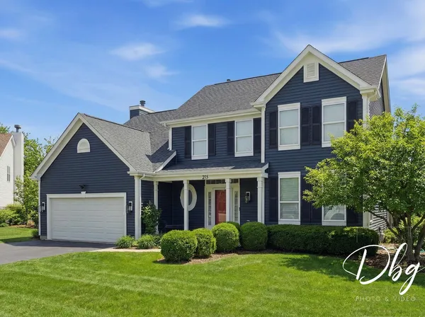 a front view of a house with garden and porch