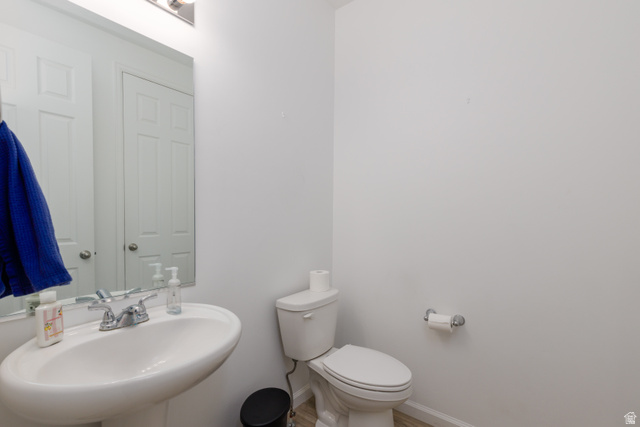 4594 West 1100 South West Point, UT 84015 - Photo 8 of 43 Pedestal sink with chrome-finish faucet, toilet, and light-toned flooring