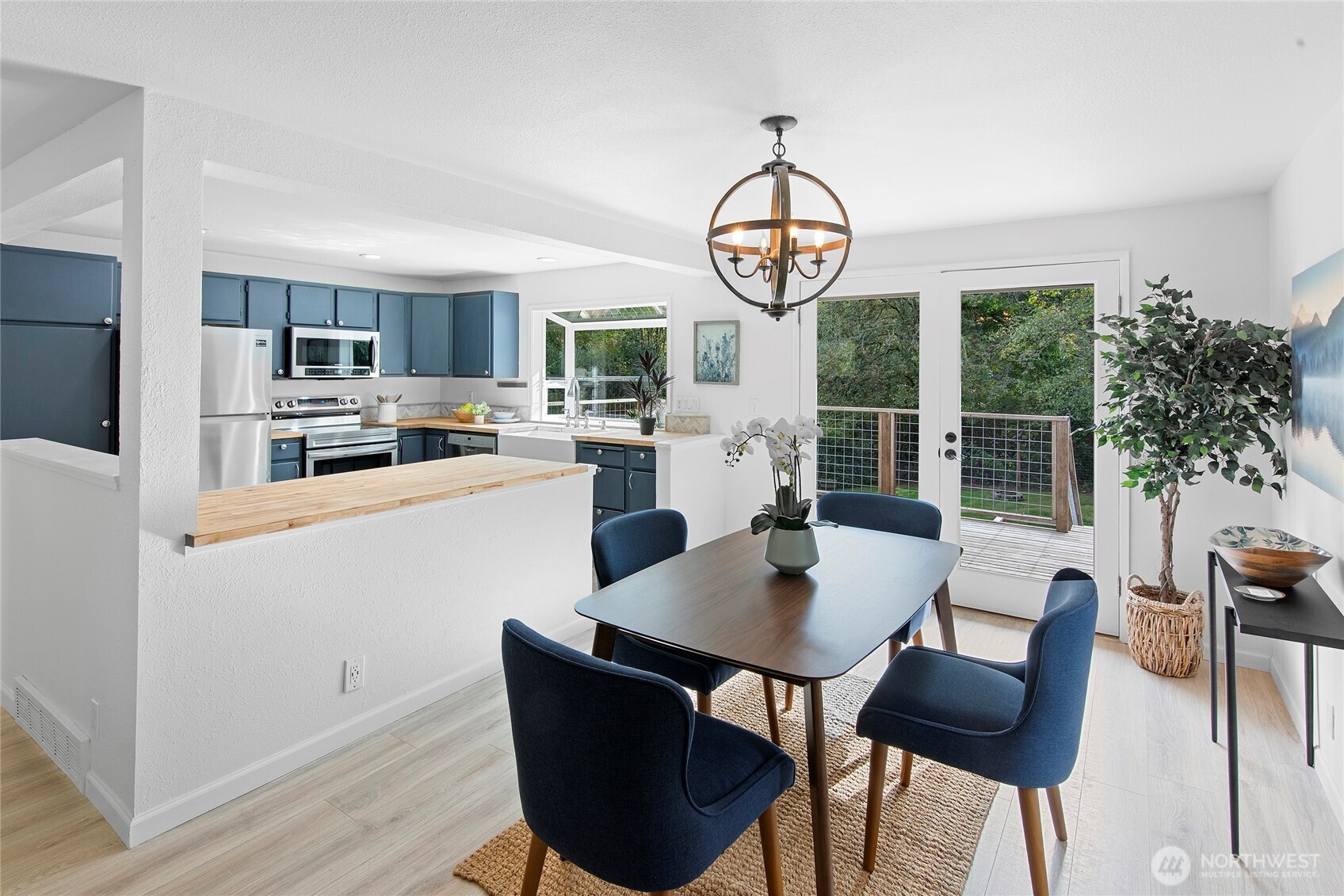 10211 Northeast Roberts Road Bainbridge Island, WA 98110 - Photo 11 of 39 a view of a dining room with furniture window and wooden floor