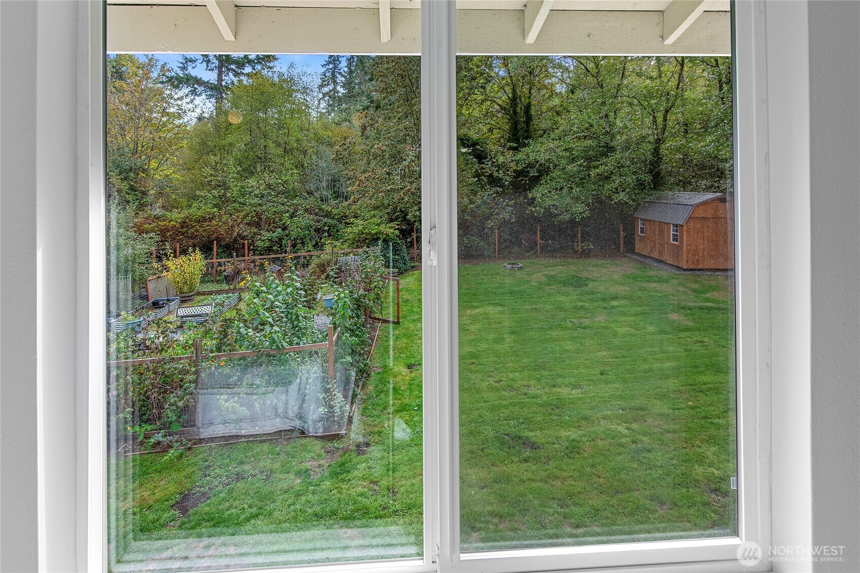 10211 Northeast Roberts Road Bainbridge Island, WA 98110 - Photo 18 of 39 a view of a room with a big yard and large trees