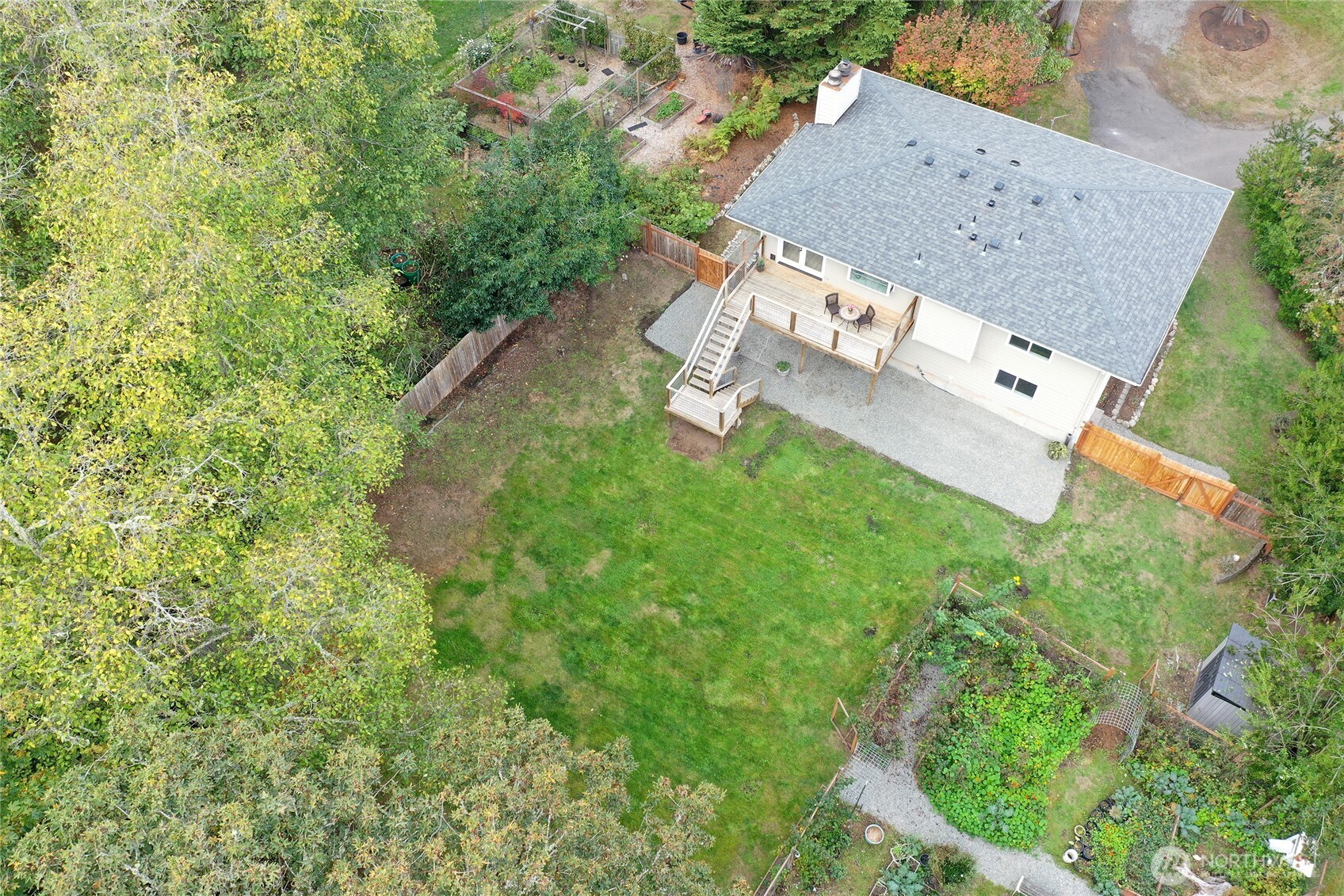10211 Northeast Roberts Road Bainbridge Island, WA 98110 - Photo 2 of 39 an aerial view of a house with garden space and street view