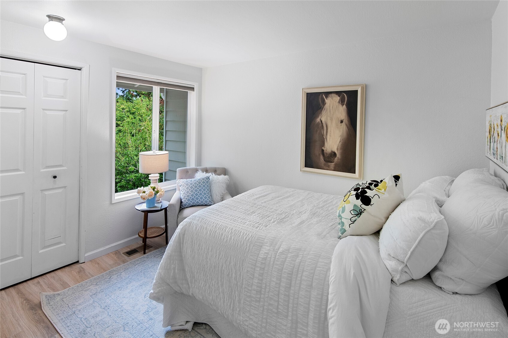 10211 Northeast Roberts Road Bainbridge Island, WA 98110 - Photo 21 of 39 a bedroom with a bed and wooden floor