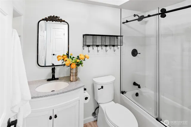 a bathroom with a sink toilet and shower