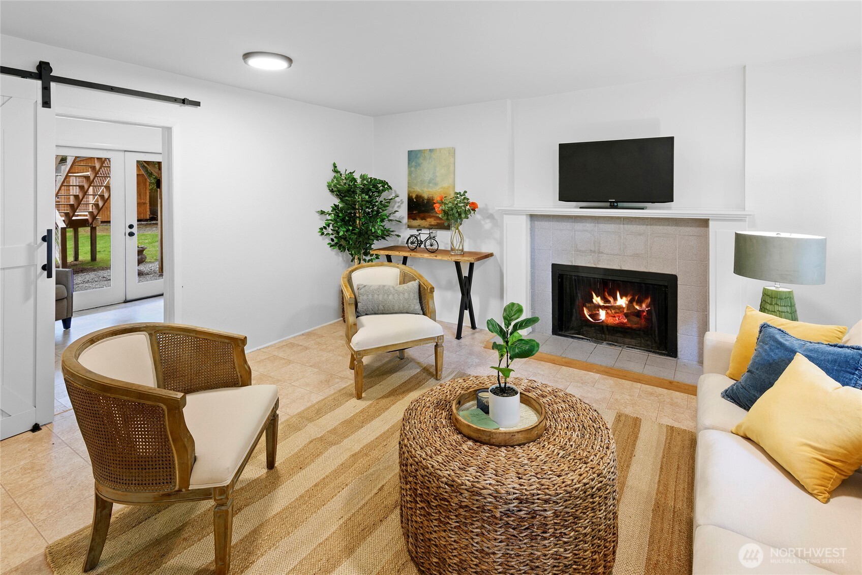 10211 Northeast Roberts Road Bainbridge Island, WA 98110 - Photo 25 of 39 a living room with furniture and a fireplace