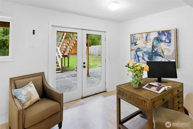 a living room with furniture and a potted plant