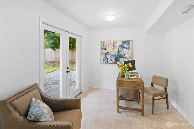 a living room with furniture and a painting on the wall