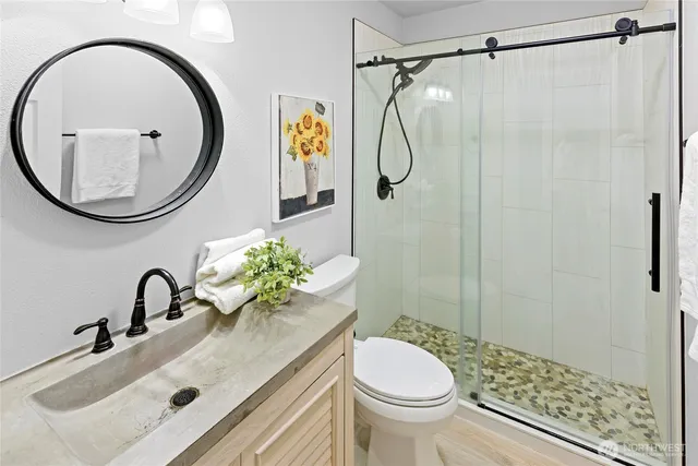 a bathroom with a sink a toilet and a mirror