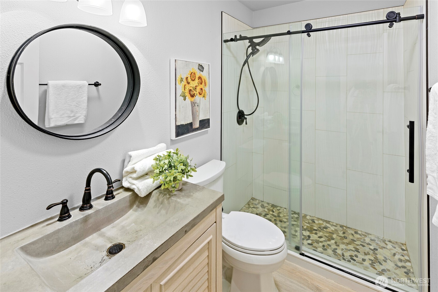 10211 Northeast Roberts Road Bainbridge Island, WA 98110 - Photo 28 of 39 a bathroom with a sink a toilet and a mirror
