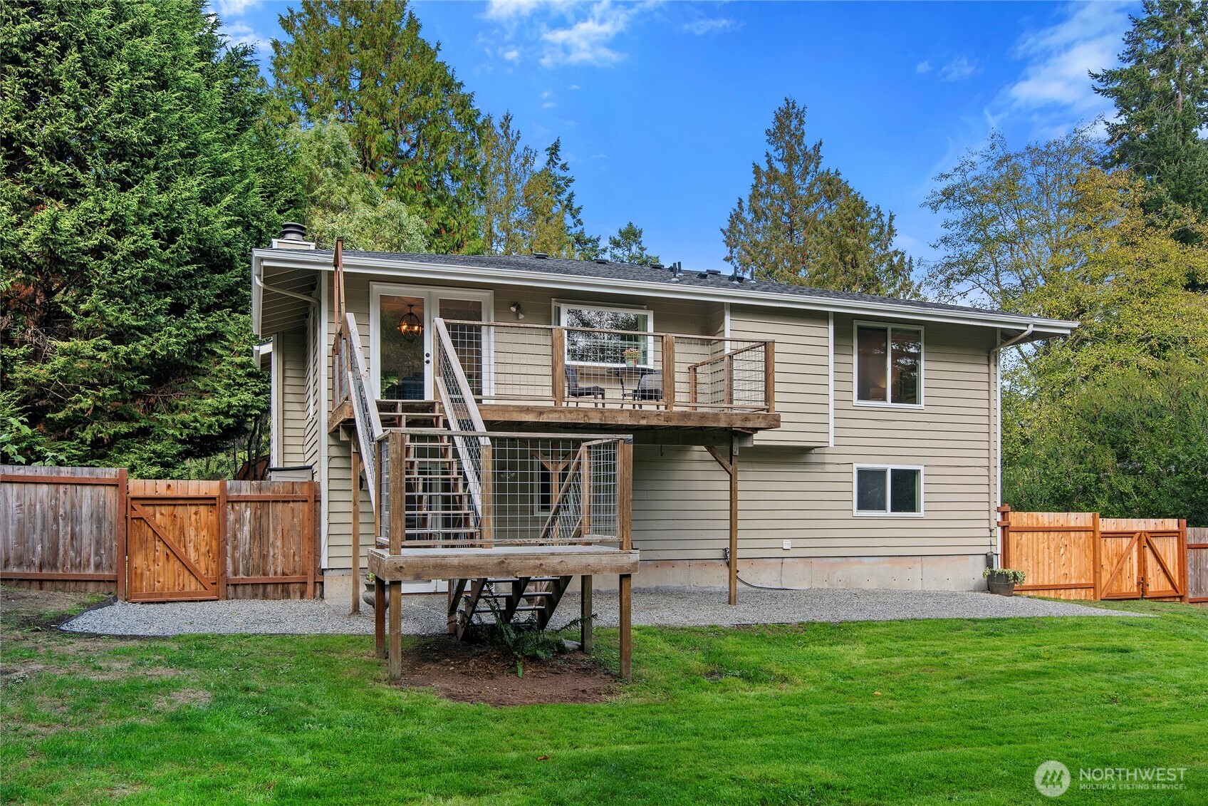 10211 Northeast Roberts Road Bainbridge Island, WA 98110 - Photo 31 of 39 a front view of a house with a garden