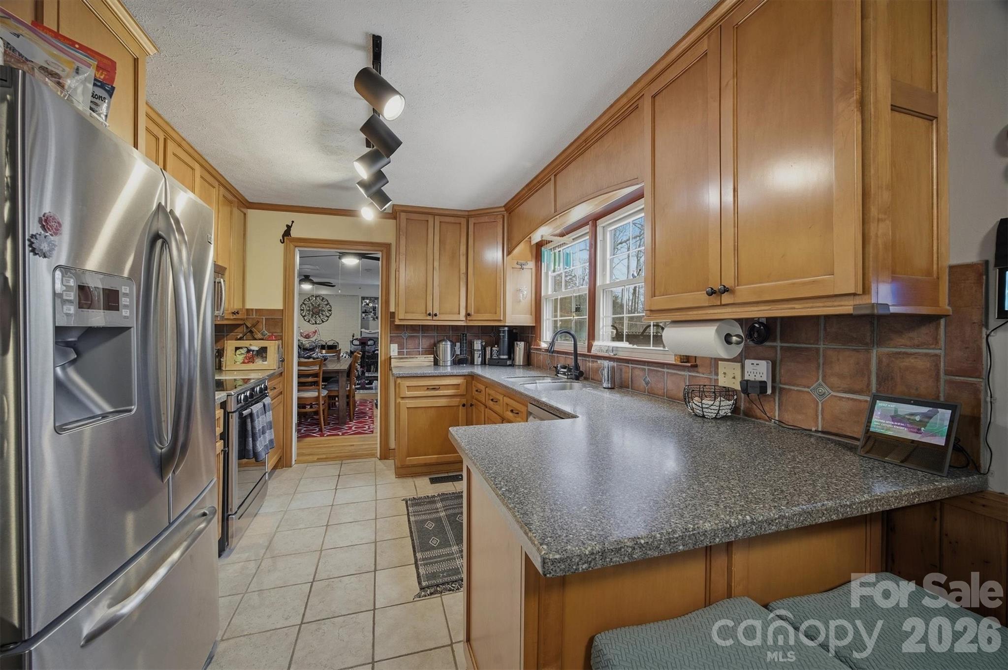 4157 Beck Road Morganton, NC 28655 - Photo 12 of 35 a kitchen with stainless steel appliances granite countertop a sink a stove and a refrigerator