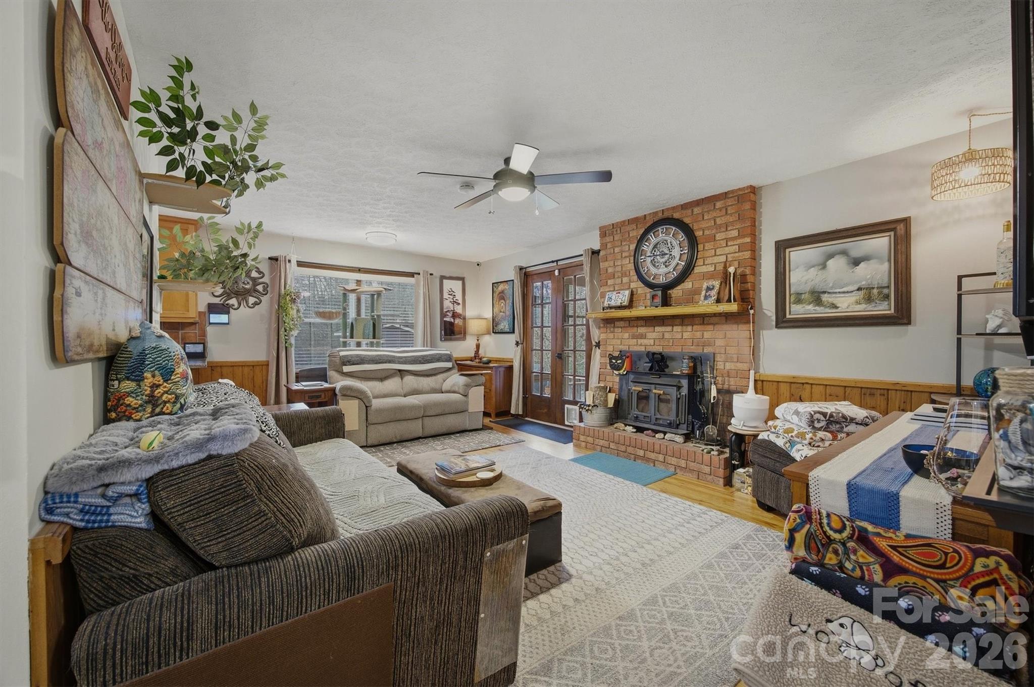 4157 Beck Road Morganton, NC 28655 - Photo 15 of 35 a living room with furniture a fireplace and a flat screen tv