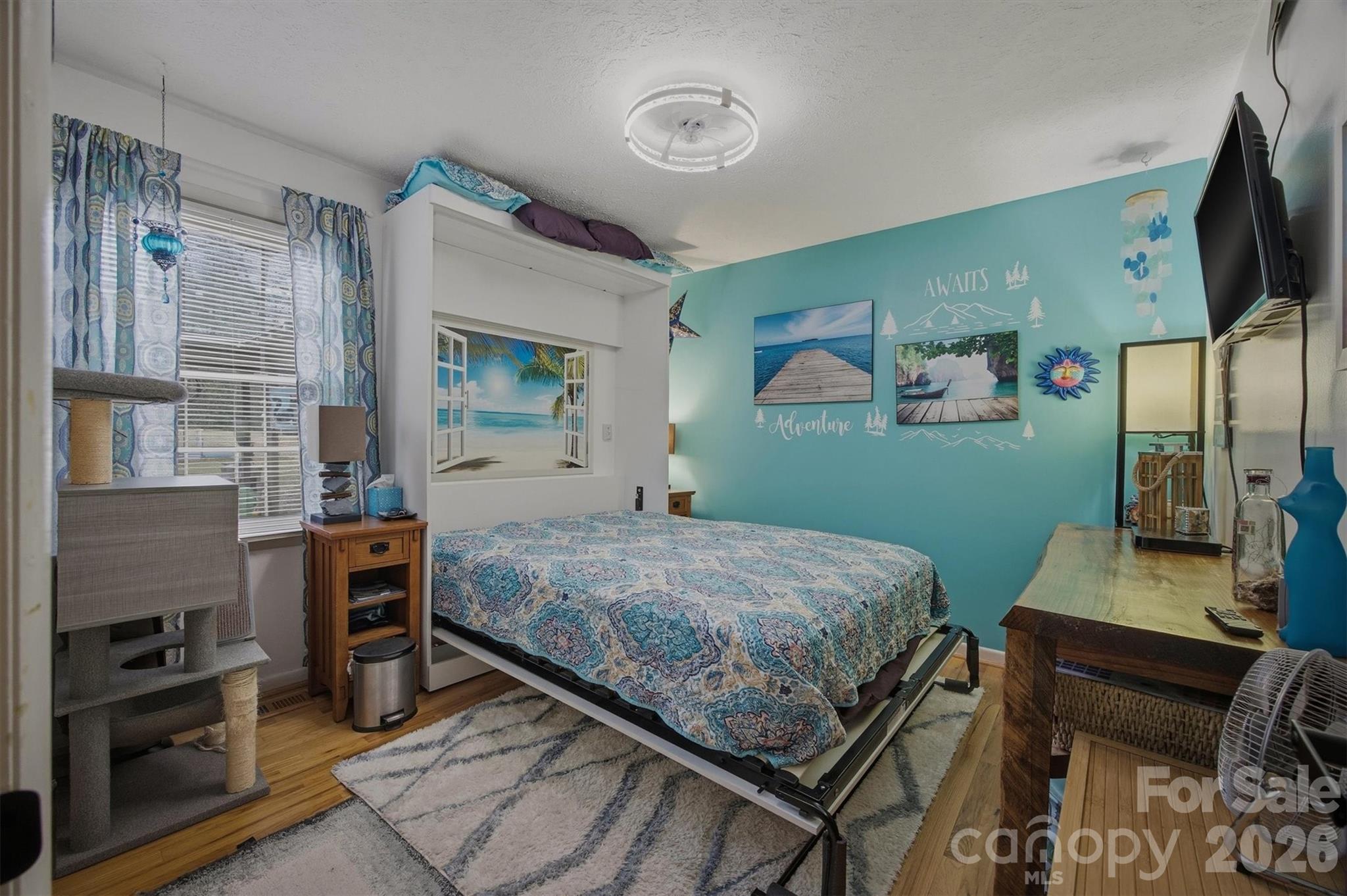 4157 Beck Road Morganton, NC 28655 - Photo 20 of 35 a bedroom with a bed and a flat screen tv