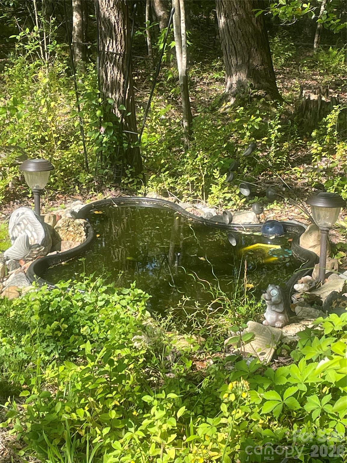4157 Beck Road Morganton, NC 28655 - Photo 33 of 35 a backyard of a house with lots of green space and tree