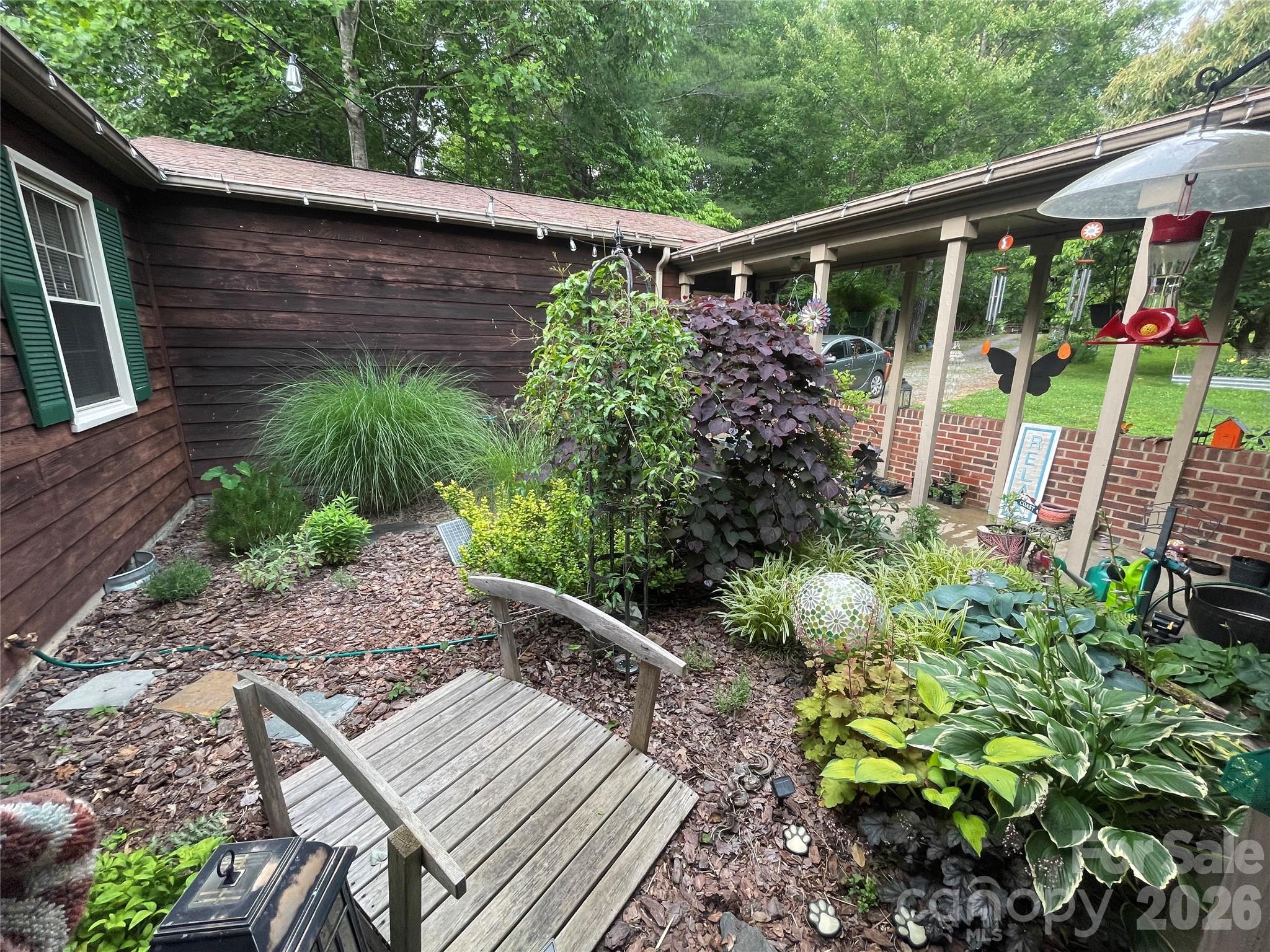 4157 Beck Road Morganton, NC 28655 - Photo 4 of 35 a backyard of a house with lots of green space and garden