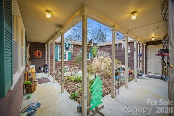 a view of a porch with dining table and chairs