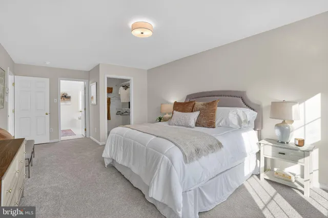 a bedroom with a bed and a mirror