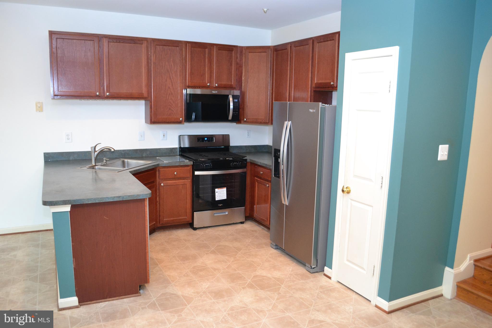 2202 Garden Lane Frederick, MD 21701 - Photo 12 of 50 a kitchen with stainless steel appliances granite countertop a stove a refrigerator and a sink