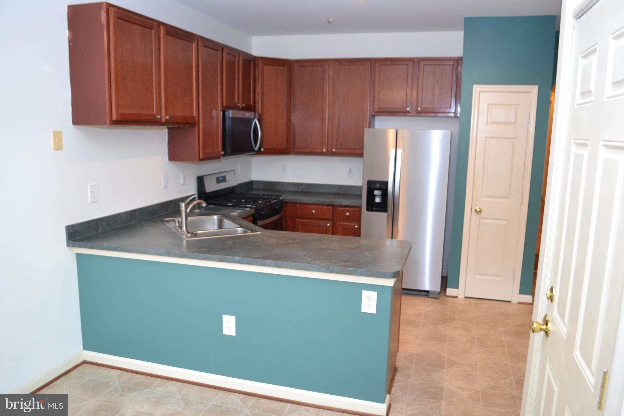 2202 Garden Lane Frederick, MD 21701 - Photo 13 of 50 a kitchen with a refrigerator a sink and a stove