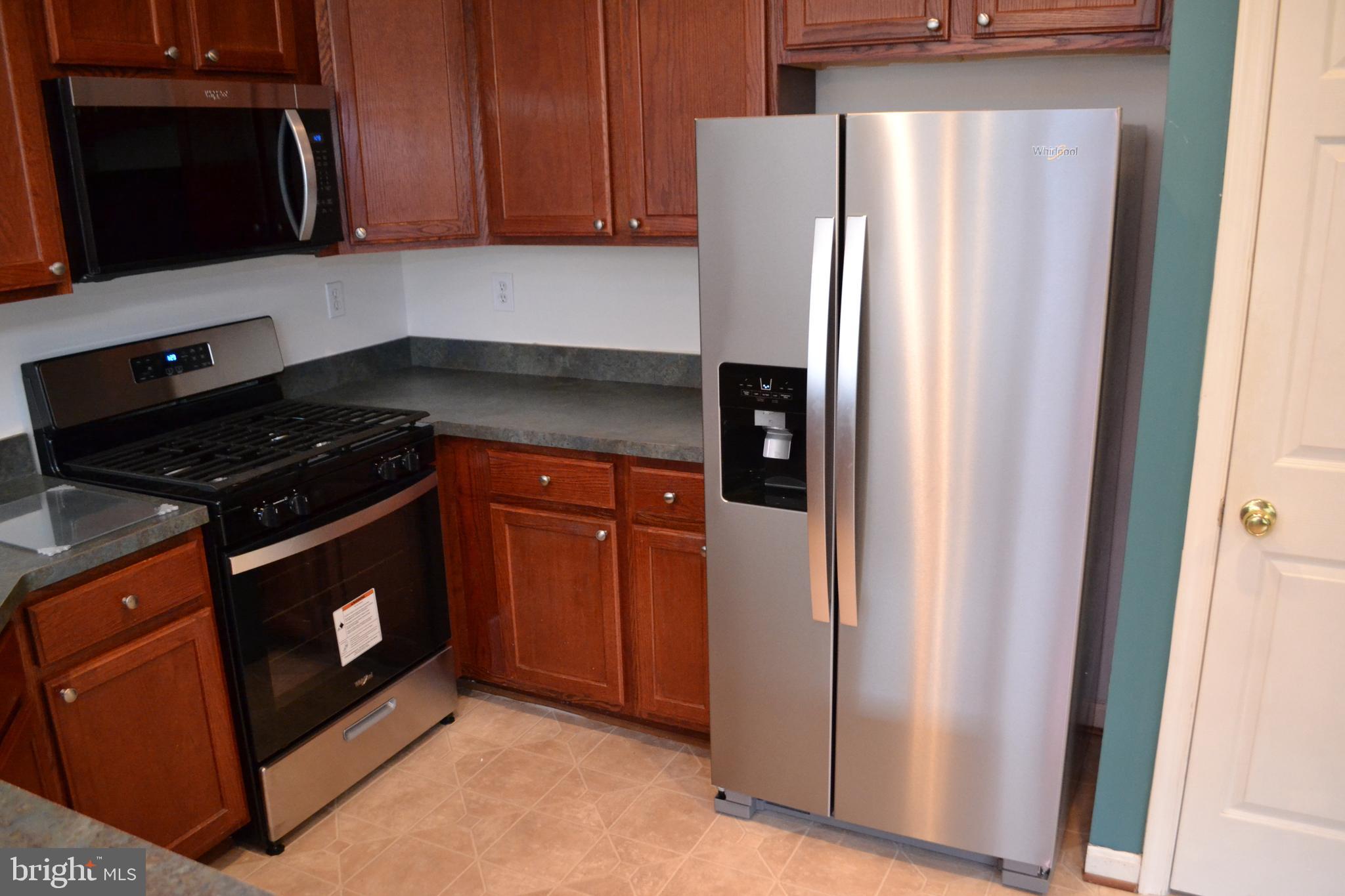 2202 Garden Lane Frederick, MD 21701 - Photo 15 of 50 a kitchen with stainless steel appliances granite countertop a refrigerator and a stove top oven