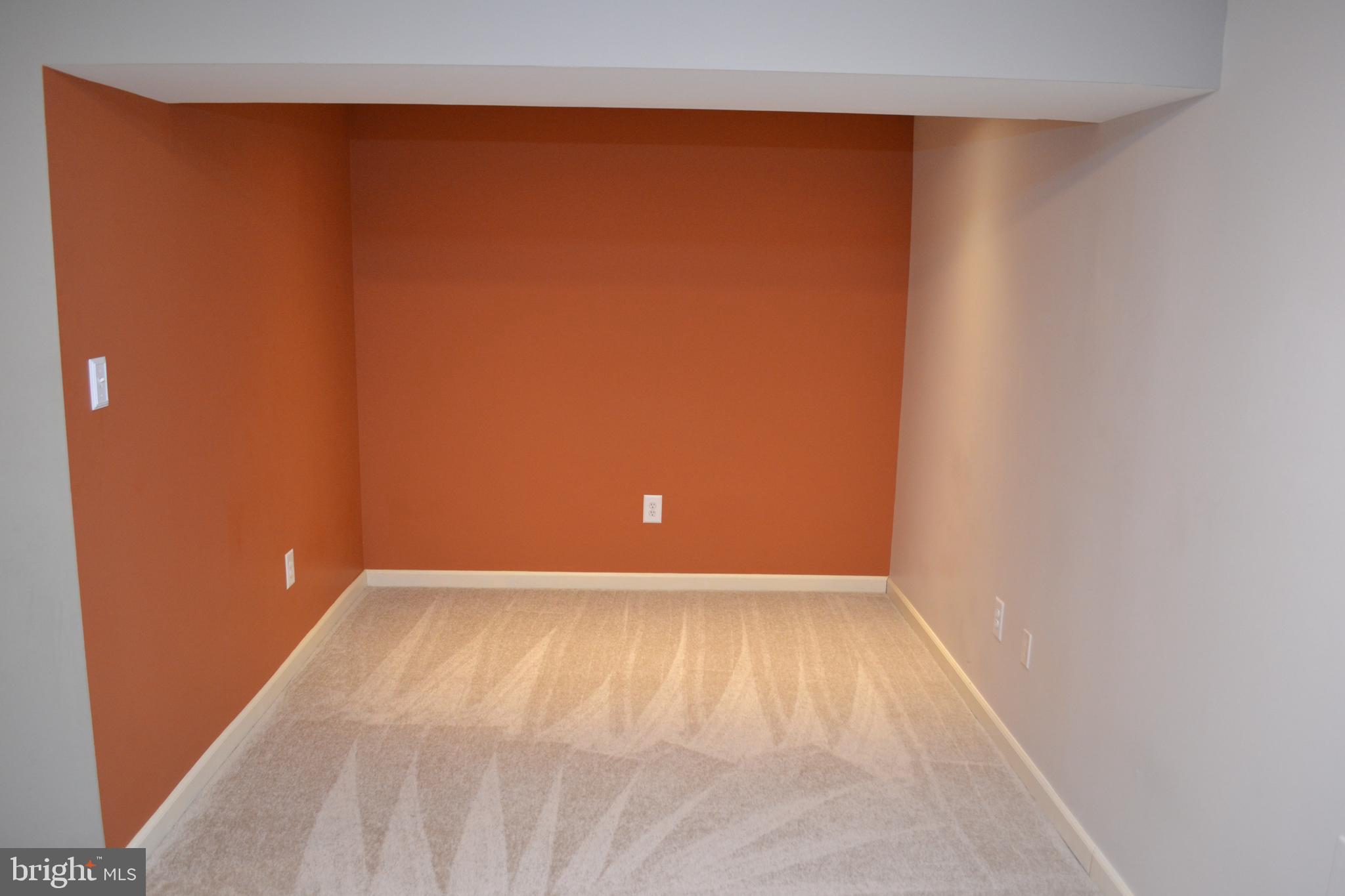 2202 Garden Lane Frederick, MD 21701 - Photo 22 of 50 a view of an empty room with wooden floor and a window
