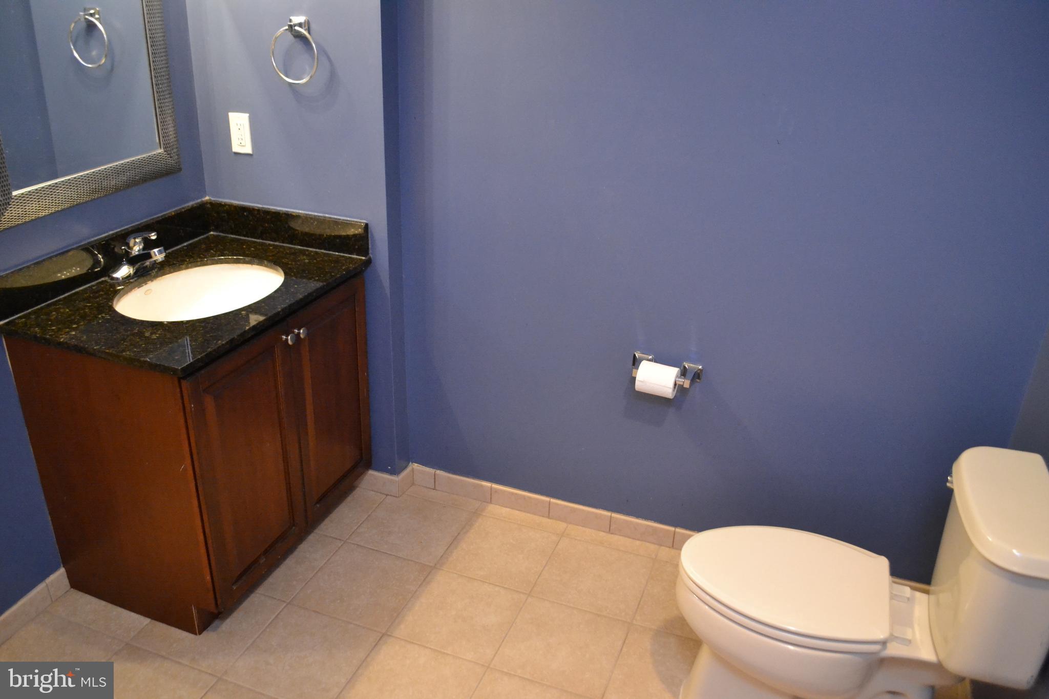 2202 Garden Lane Frederick, MD 21701 - Photo 25 of 50 a bathroom with a granite countertop toilet and a sink